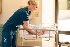 Nurse taking care of newborn