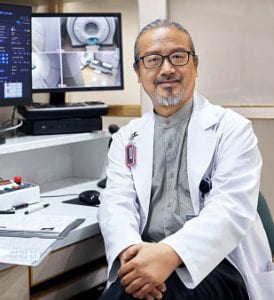 Doctor sitting in front of imaging screens