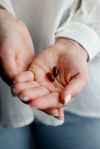 Pills in the palm of woman's hand